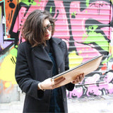 Leather portfolio depicting the golden ratio and an ancient Greek tempel with a model in urban environment