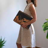 woman holding portfolio with the abduction of the daughters of Leucippus from a sanctuary of Aphrodite