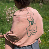 woman wearing female salmon pink cotton stole shawl scarf modern cycladic idol in nature