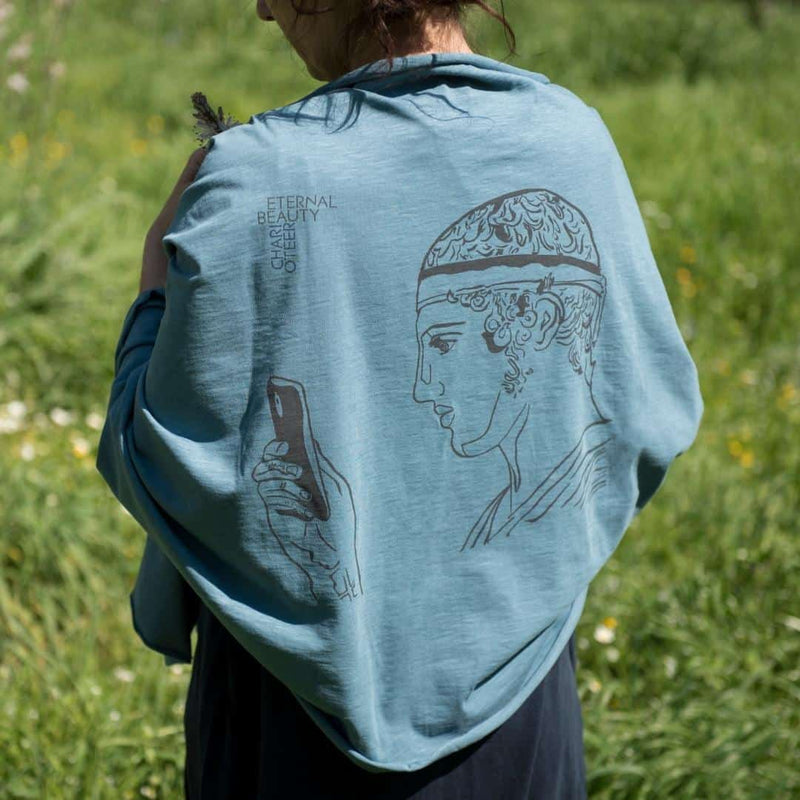Charioteer statue depicted in a modern Greek shawl - blue color in a field
