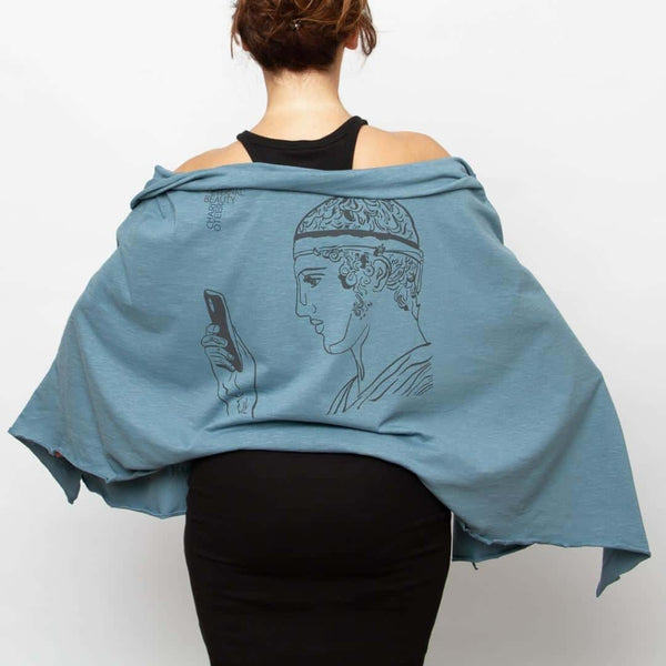 Charioteer statue depicted in a modern Greek shawl - blue color